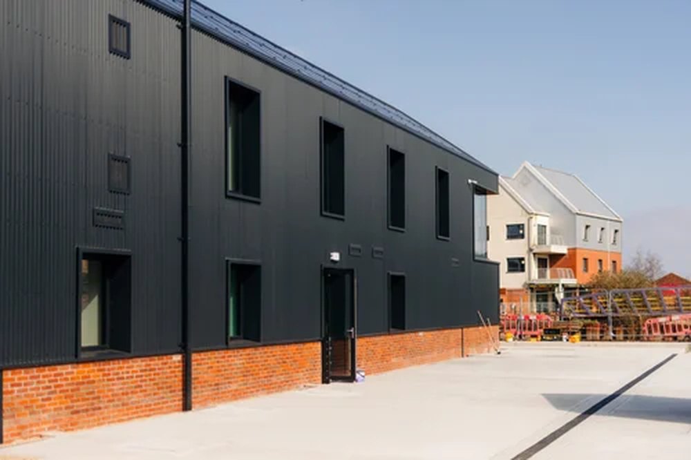 Aluminium windows and door on a black-clad commercial building